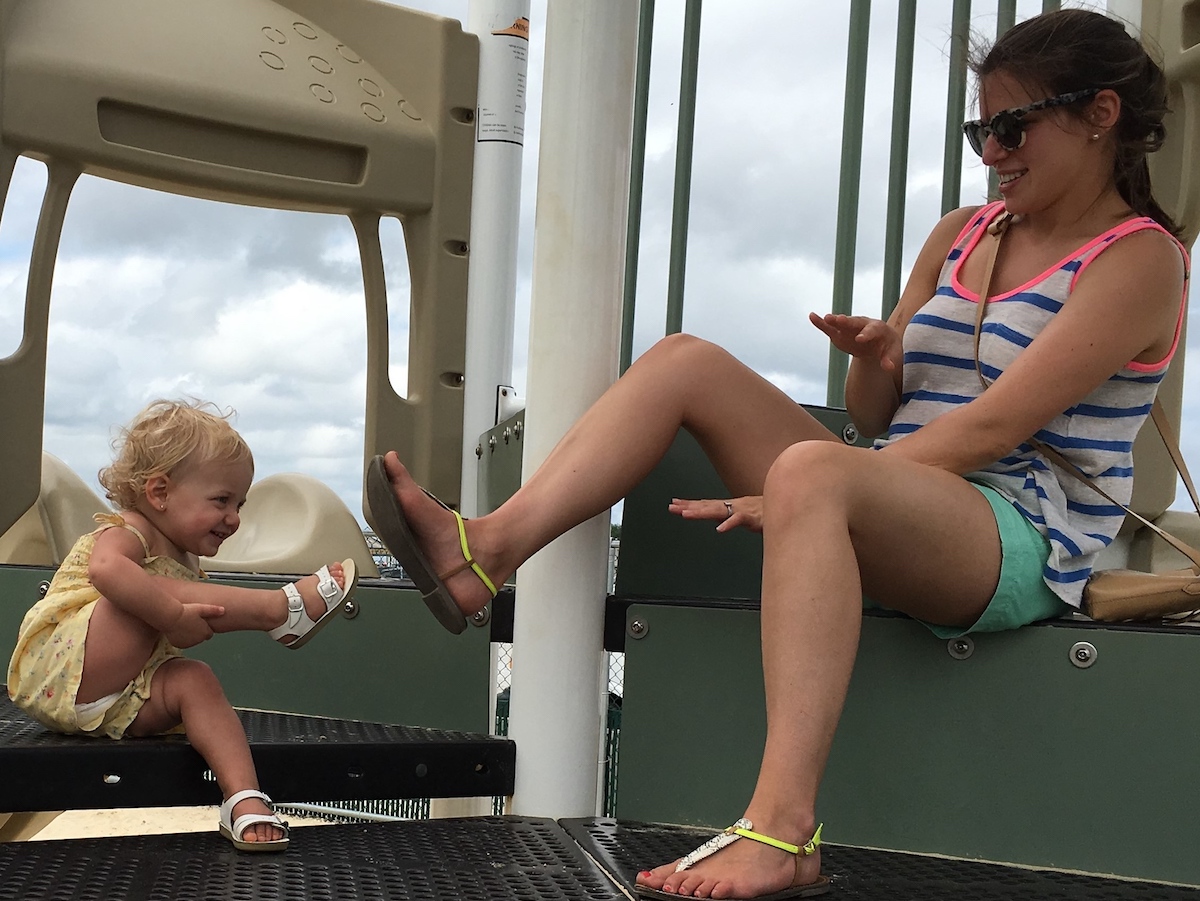 toddler and mom comparing shoes